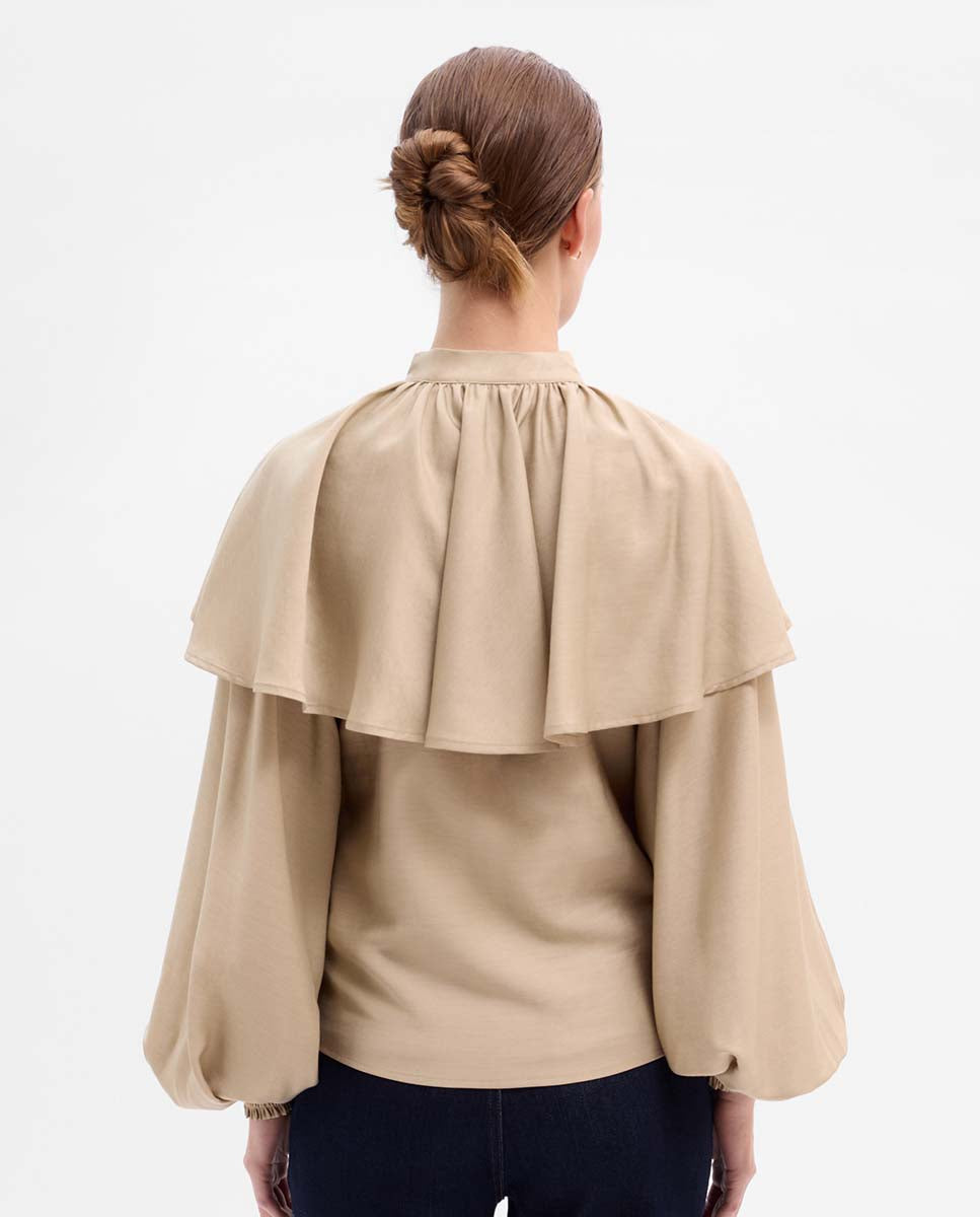 Blusa capa manga abullonada